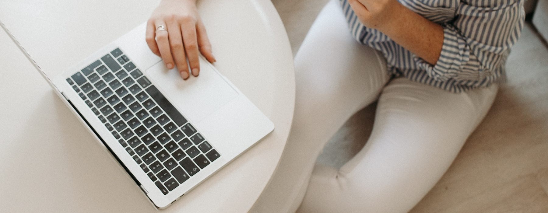 a person sitting on the floor with a laptop