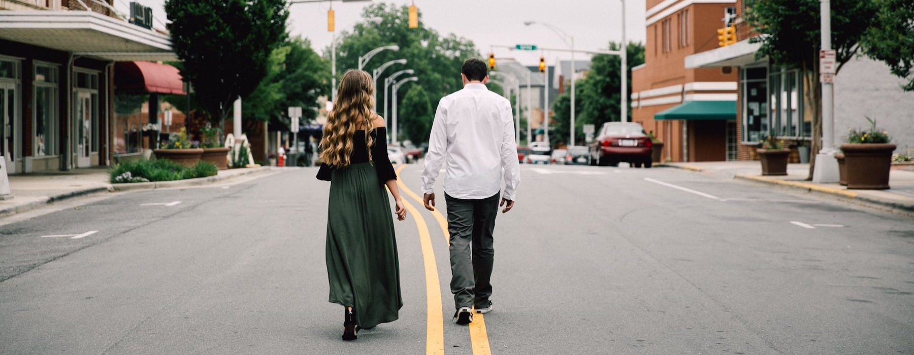 a man and woman walking down a street