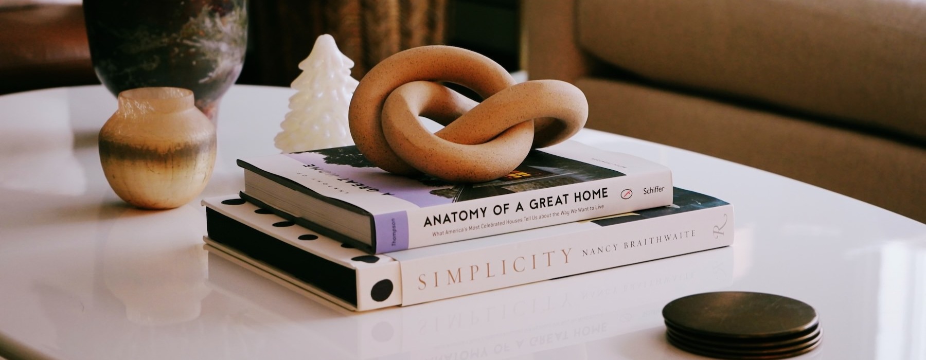 a coffee table with books and a plant